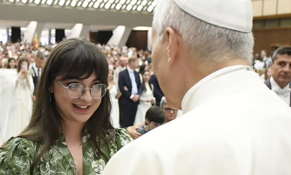 Student Francesca Ramos smiling at Monsignor Juan Antonio Cruz Serrano.